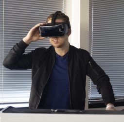 Man in Black Jacket Holding VR Goggles